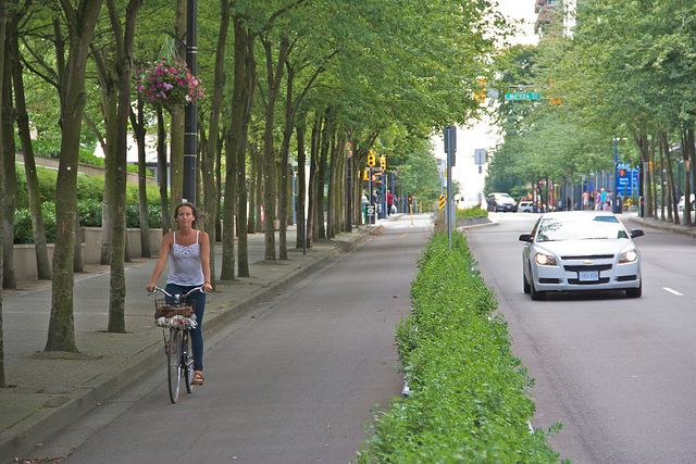 Biker in bike lane downtown Vancouver